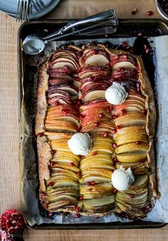 an apple and raspberry tart with whipped cream on top is ready to be eaten