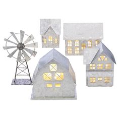 three models of houses and a windmill are shown in this image, with the lights on