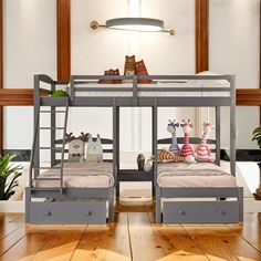 two bunk beds sitting next to each other on top of a wooden floor