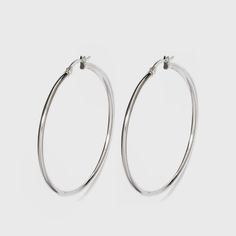 Spruce up your everyday look with these high-fashion sterling silver hoop earrings. With a silver finish, these medium hoop earrings give you endless styling options, complementing everything from your comfiest tees to sheath dresses and more. Complete your look with layered silver-finished necklaces or a chunky chain link bracelet for a chic, coordinated look. Gender: female. Age Group: adult. Pattern: Solid. Classic Metal Hoop Earrings For Everyday, Trendy Hypoallergenic White Gold Hoop Earrings, Iconic Brunettes, Silver Hoop Earrings Medium, Clean Silver Jewelry, Silver Hoop Earring, Earring Stack, Simple Hoop Earrings, Medium Hoop Earrings