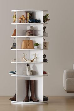 a white shelving unit with shoes and purses on it in a living room