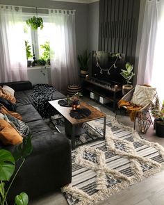 a living room filled with furniture and plants