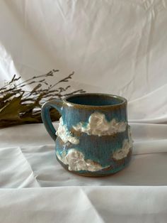 a blue and white mug sitting on top of a table