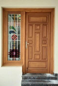 a wooden door with glass panels and steps