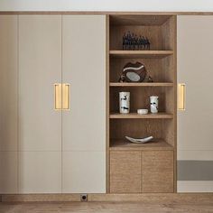 an empty room with wooden shelves and white cupboards