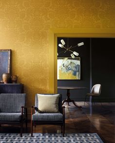 a living room filled with furniture and yellow walls