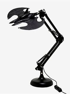 a black desk lamp with a batman figure on it's arm and the light turned on