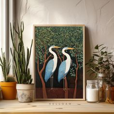 two blue and white birds sitting on top of a wooden shelf next to potted plants