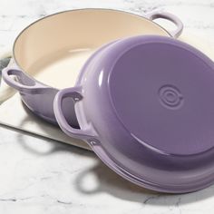 a casserole dish with a purple lid on a white plate