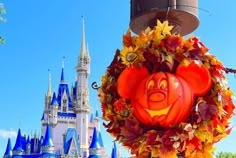 a pumpkin wreath in front of the castle at disney's halloween wonderland, disneyland world