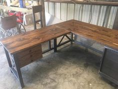 two wooden desks sitting next to each other on top of cement floored ground