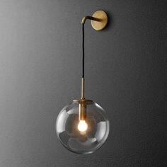 a light that is on the wall with a glass ball hanging from it's side