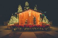 an outdoor christmas scene with lights and decorations