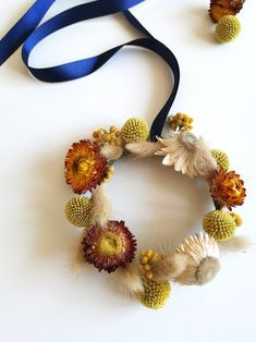 a blue ribbon and some flowers on a white table with it's end cut off