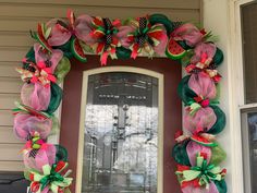 a wreath on the front door of a house decorated with mesh and watermelon