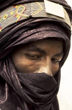 a man wearing a black scarf and head covering