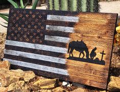 a wooden sign with an american flag painted on it and a silhouette of a horse