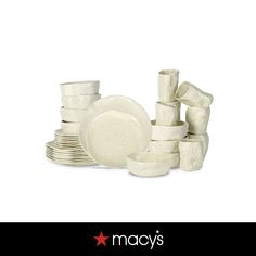 a stack of white dishes and cups with the words macy's written below it