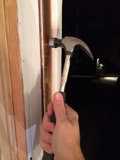 a person holding a hammer in their hand