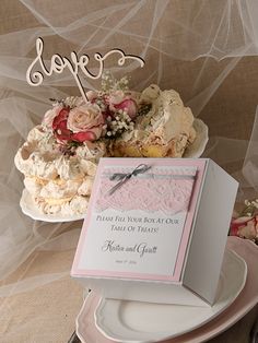 a table topped with plates and cakes covered in frosting next to a sign that says love