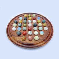 a wooden board with marbles on it