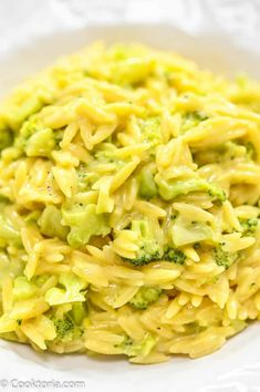 a white bowl filled with pasta and broccoli