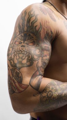 a man with tattoos on his arm and chest