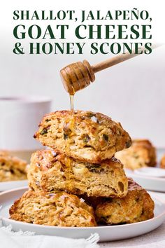 a stack of oatmeal and honey scones sitting on top of a white plate