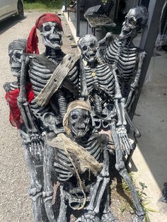 three skeleton statues sitting next to each other