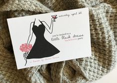 a card with a black dress on it