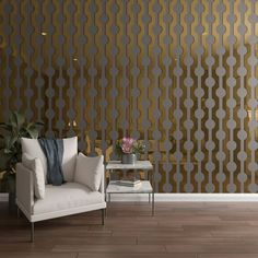 a white couch sitting next to a table on top of a hard wood floor under a golden wall