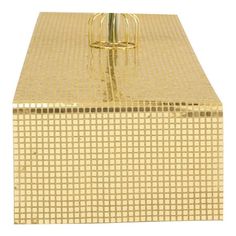 a golden box with a metal handle on the top and bottom, in front of a white background