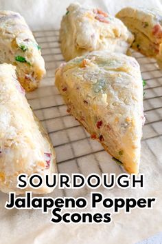 there are several scones on the cooling rack with text overlay that reads sourdough jalapeno popper sons