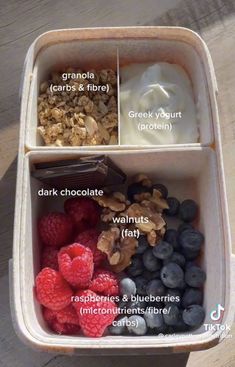 a container filled with granola, yogurt and berries