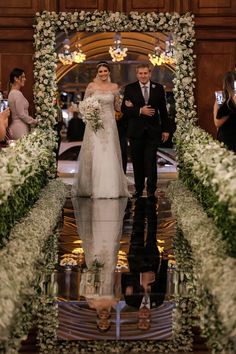 the bride and groom are walking down the aisle