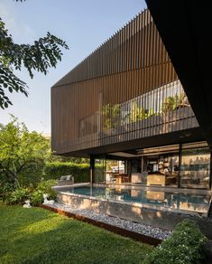 an outdoor swimming pool in front of a house