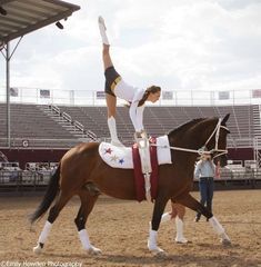 a woman riding on the back of a brown horse