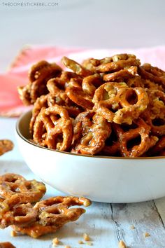 a white bowl filled with pretzels on top of a table