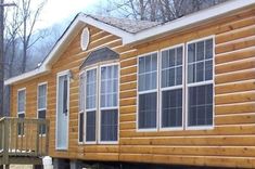 a small wooden house sitting on the side of a road