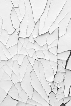 cracked white paint on the side of a wall