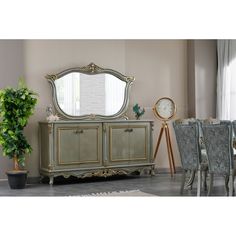 a dining room table with chairs and a large mirror