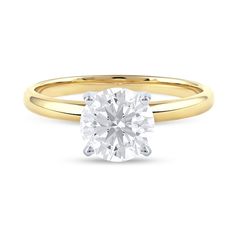 a yellow gold engagement ring with a round cut diamond in the center, on a white background