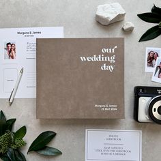 the wedding day book is surrounded by photos, cards and other personalized items including a camera