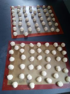 two trays filled with dough on top of a table