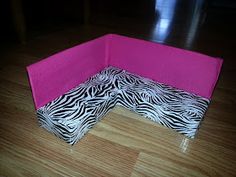 a pink and zebra print couch sitting on top of a hard wood floor