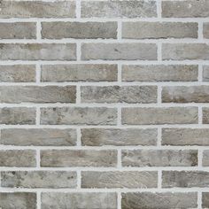 a brick wall made out of grey bricks