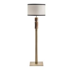 a lamp that is on top of a white surface with a black and gold shade