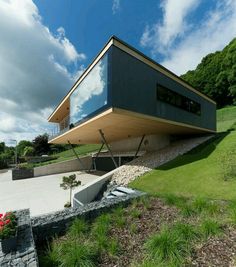 a modern house on the side of a hill