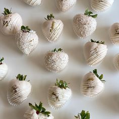 several white chocolate covered strawberries arranged on a table