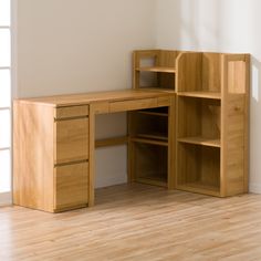 a wooden desk with shelves and drawers in an empty room on a hard wood floor